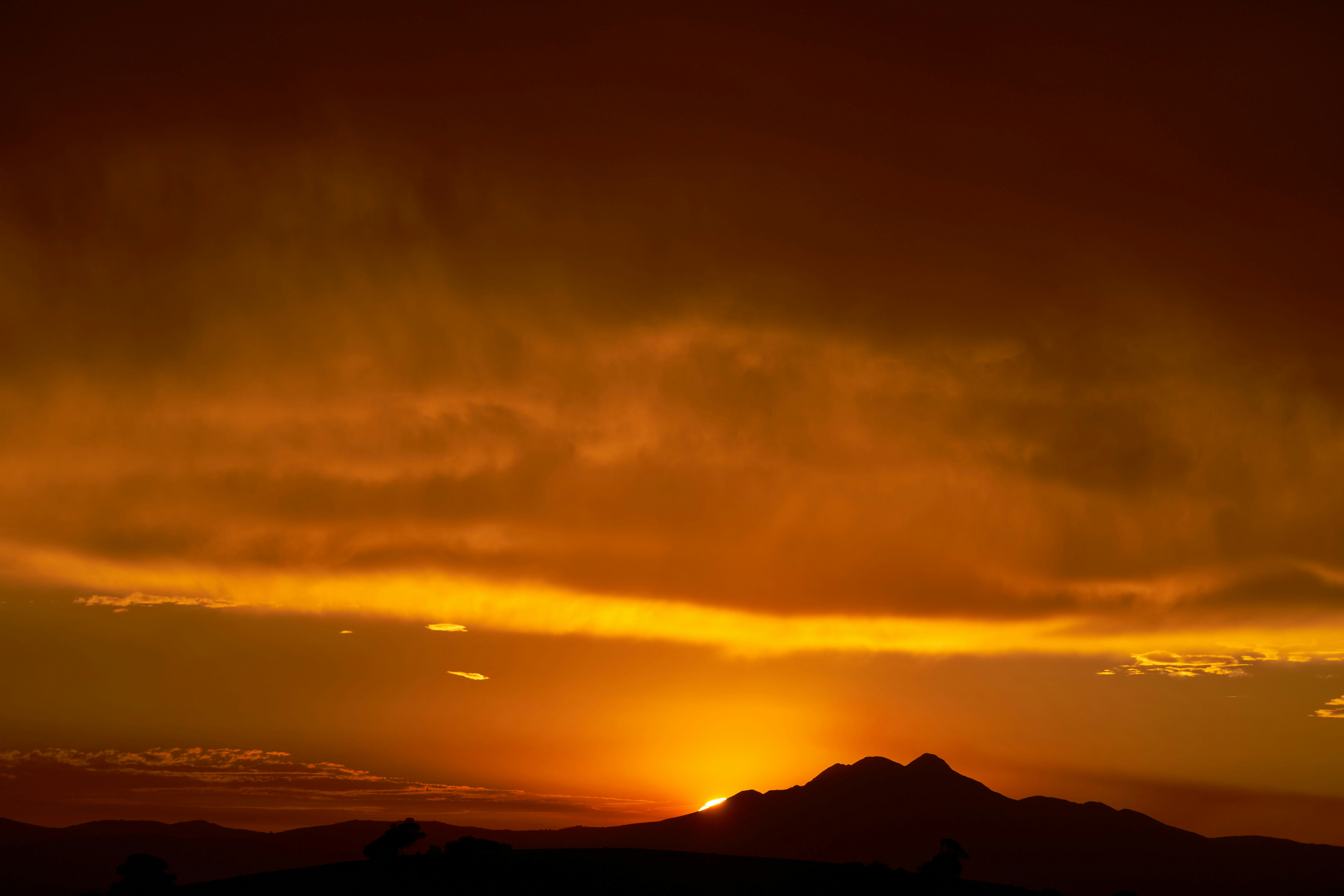 silhouette of mountain during sunset