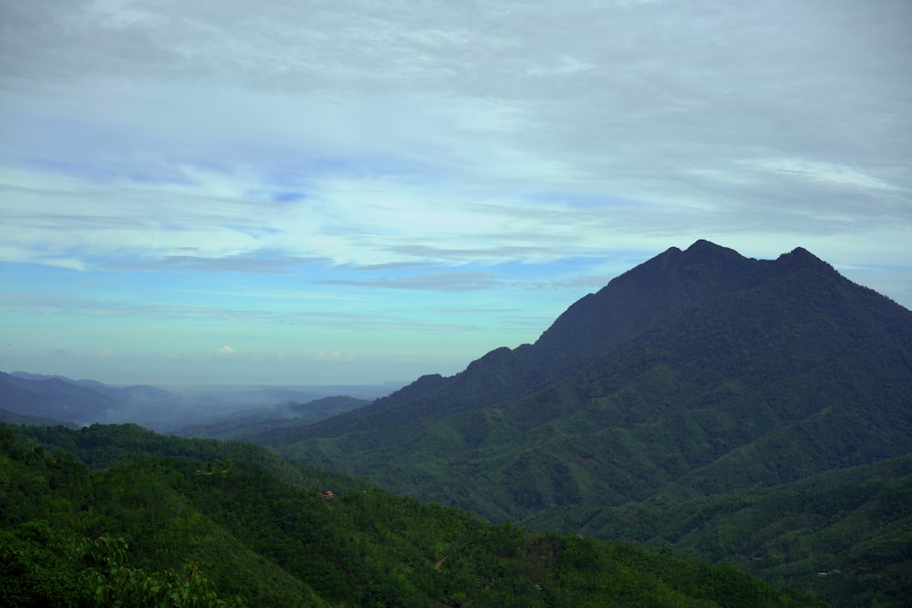 green mountains under white clouds during daytime