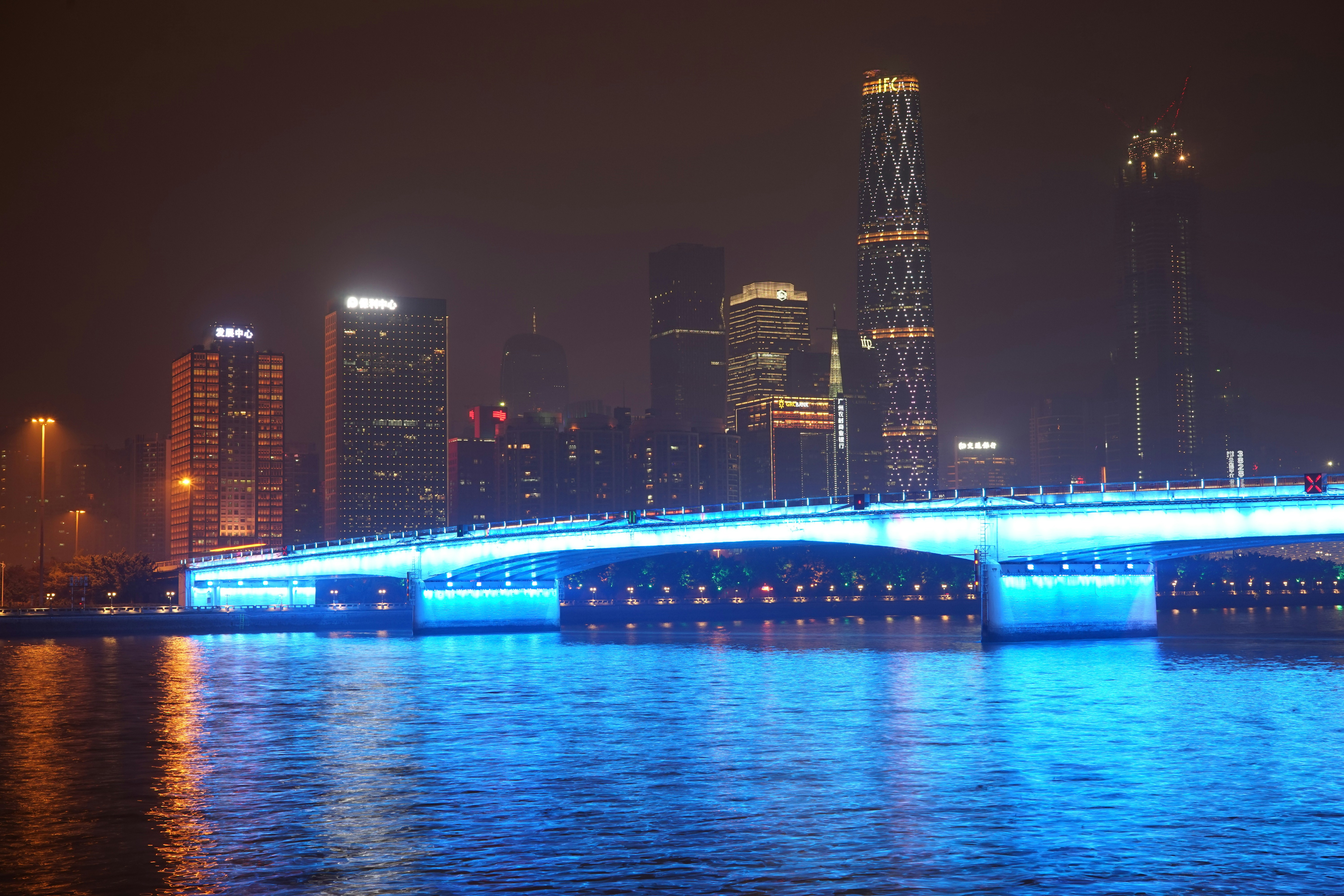 lighted bridge over water during night time