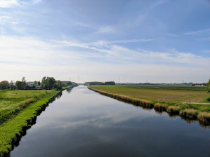 A serene rural landscape with a compact wastewater treatment system blending into nature.