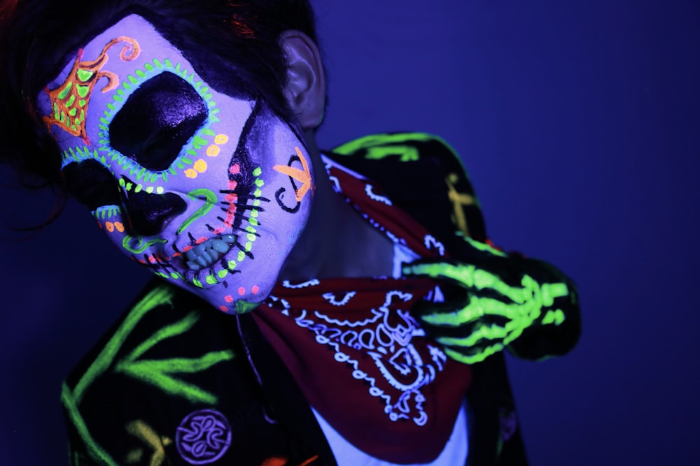 man in green and black shirt with black and white floral mask