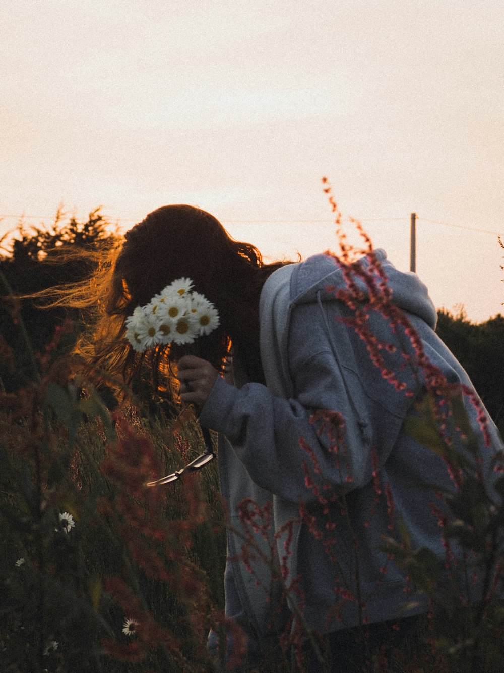 person in black jacket with white flower on head