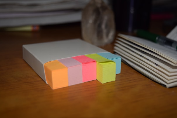 Stack of printed scripts with colorful sticky notes marking key scenes.