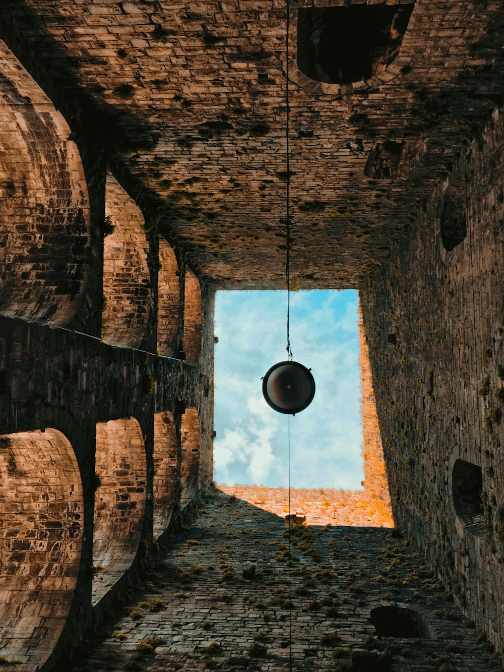 black pendant lamp on brown brick wall