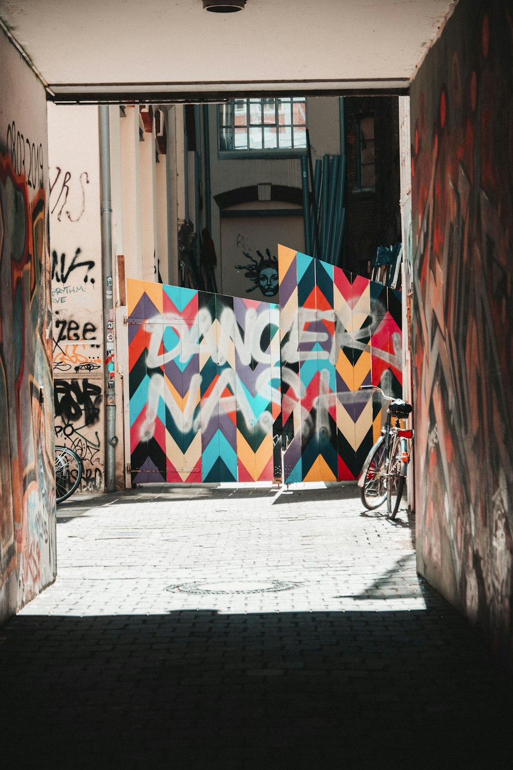 bicycle parked beside wall with graffiti