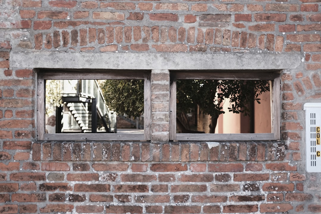 brown brick wall with black framed window