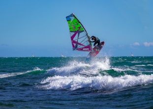 man surfing on sea waves during daytime