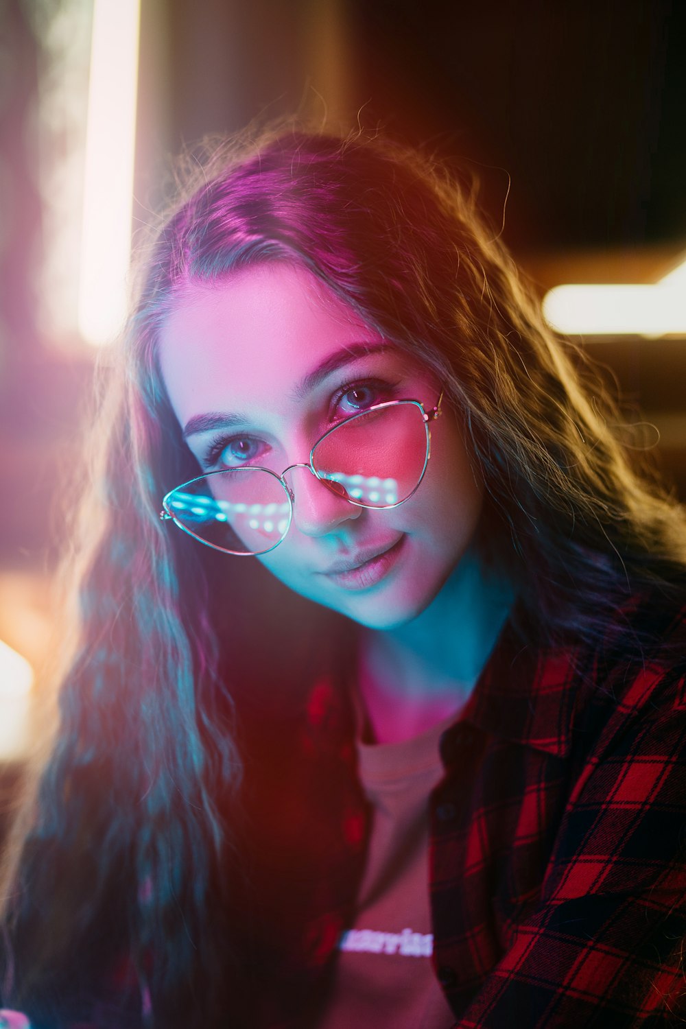 woman in red and black plaid shirt wearing eyeglasses