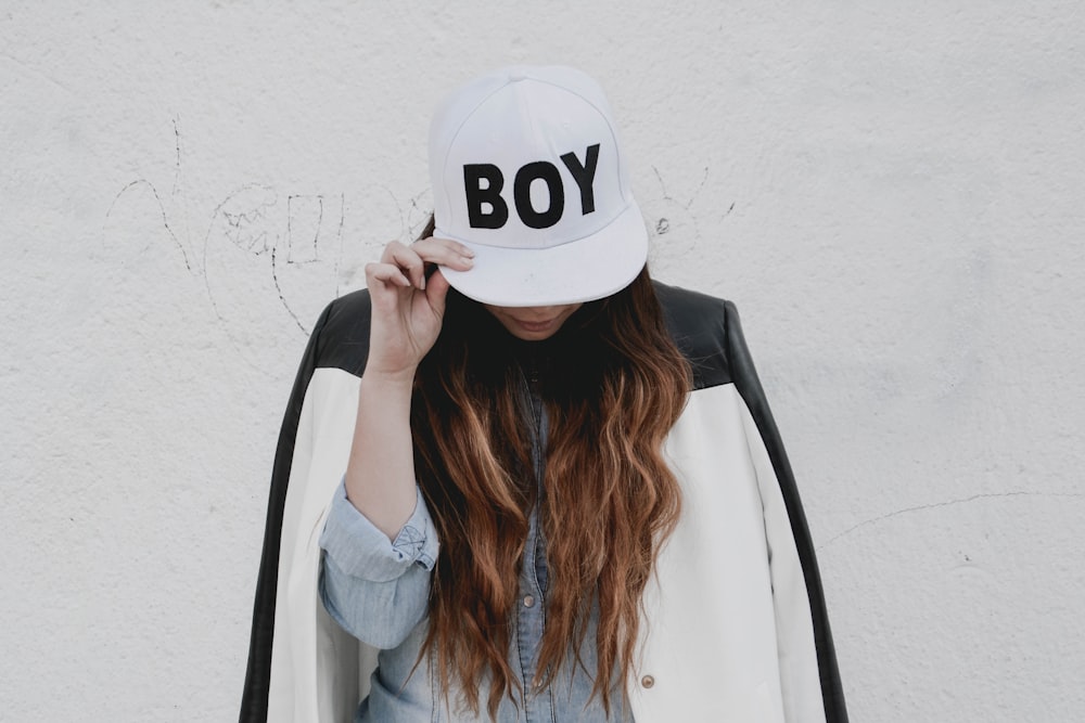 woman in white nike fitted cap and gray long sleeve shirt