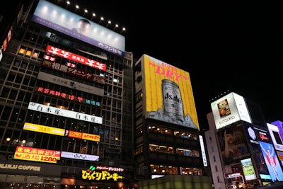 A vibrant billboard showcasing the Sanju brand in a busy cityscape.