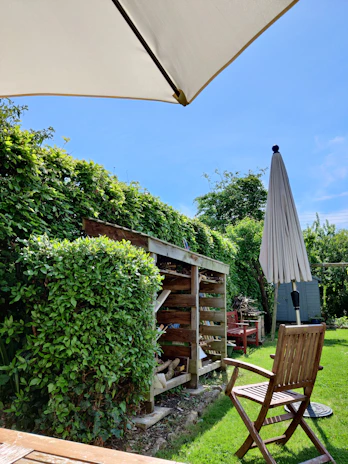 A sunlit backyard featuring the waterproof awning and matching storage box in use.