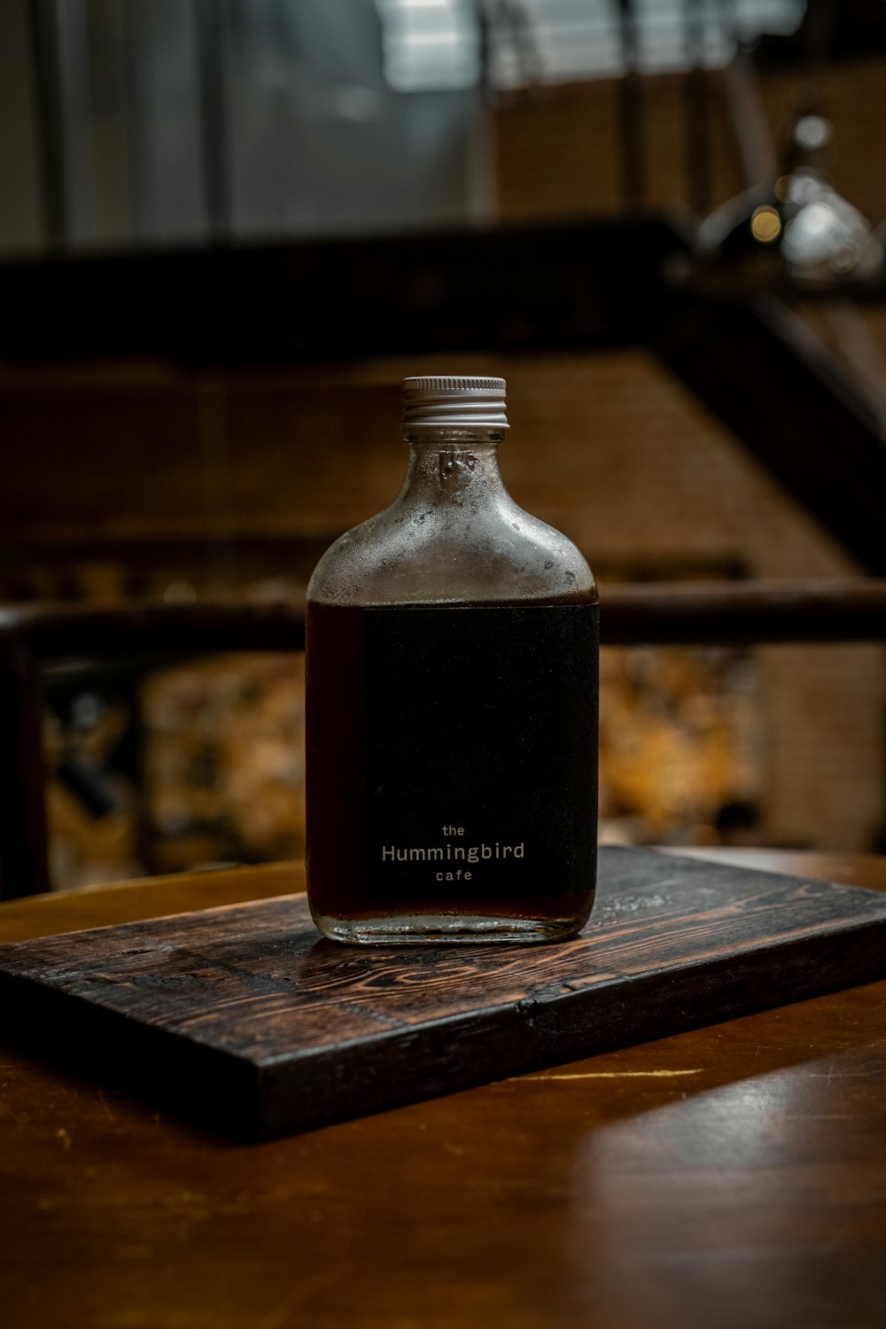 black and white glass bottle on brown wooden table