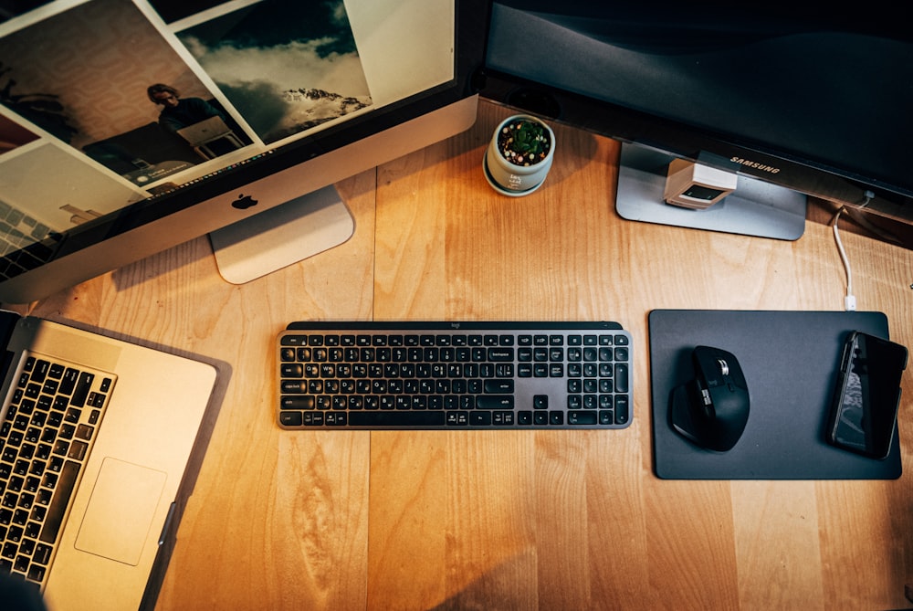 black and silver computer keyboard beside black computer mouse