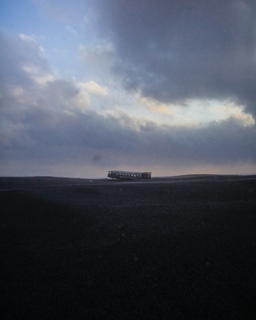 white and black bus on black asphalt road under white clouds and blue sky during daytime