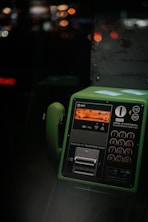 green telephone on brown wooden table