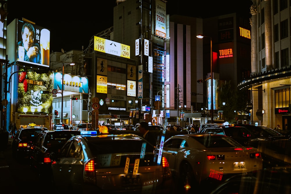 cars on road near buildings during night time