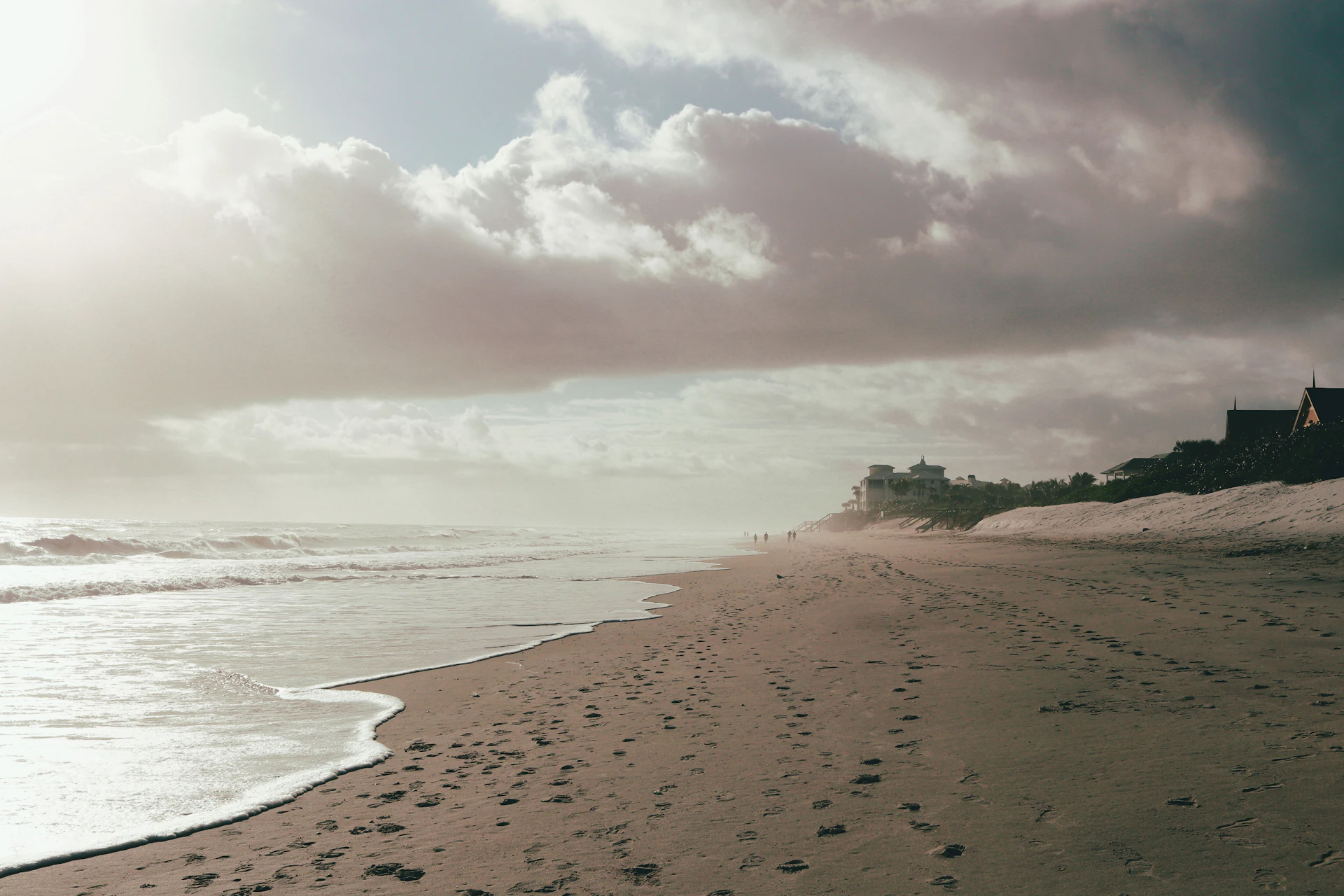 Panoramic view of a pristine Atlantic Ocean beach in Florida with calm turquoise water, white sand and clear blue skies