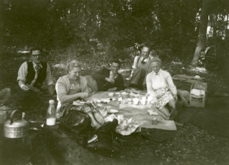 A group of friends enjoying a picnic, dressed in trendy outdoor wear.