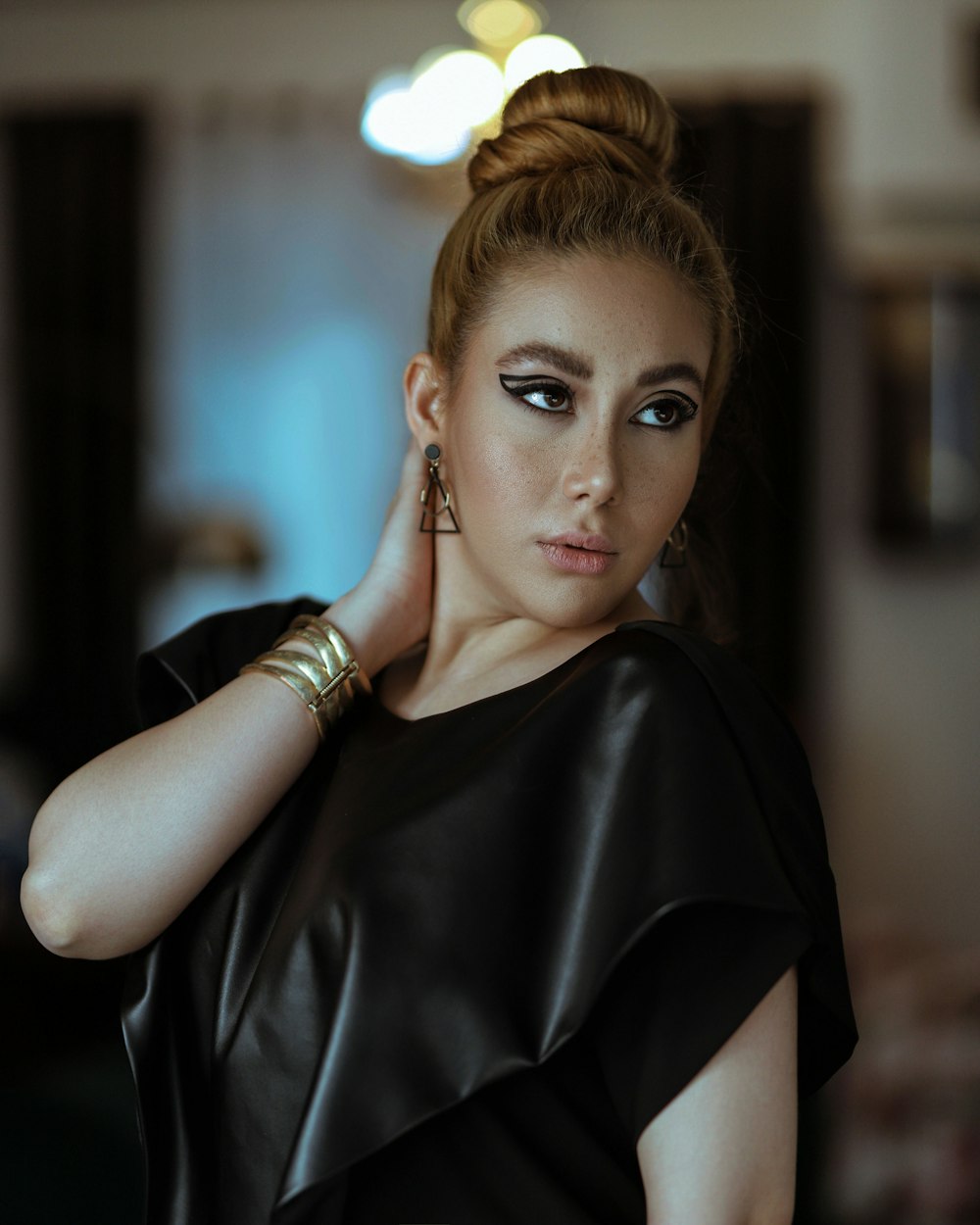 woman in black dress wearing gold bracelet