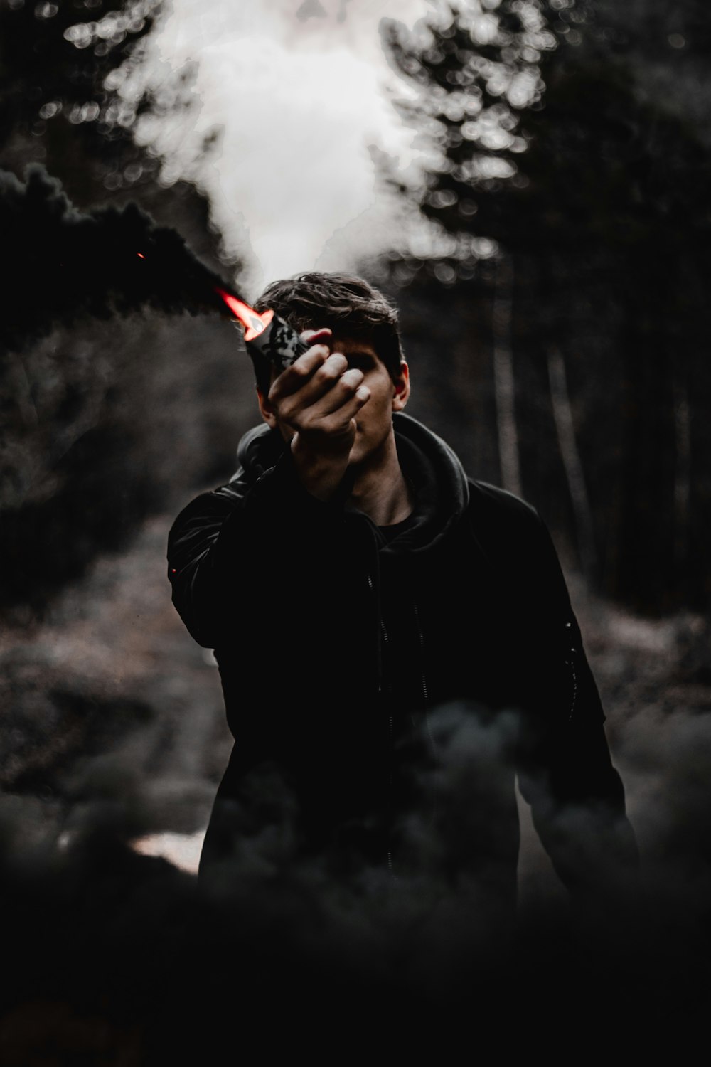 man in black leather jacket smoking cigarette