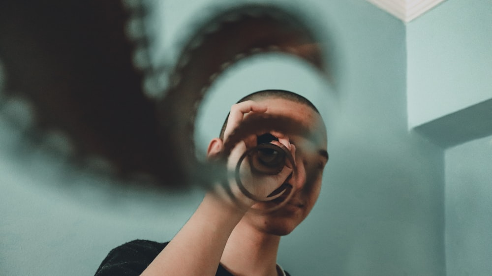 woman in black shirt holding her face