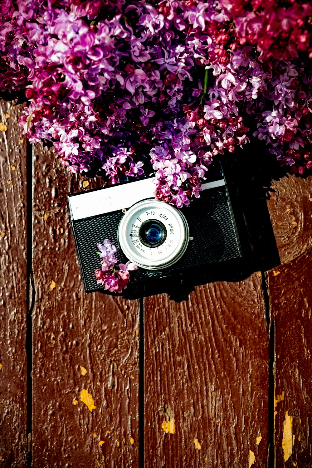 black and silver camera on brown wooden surface
