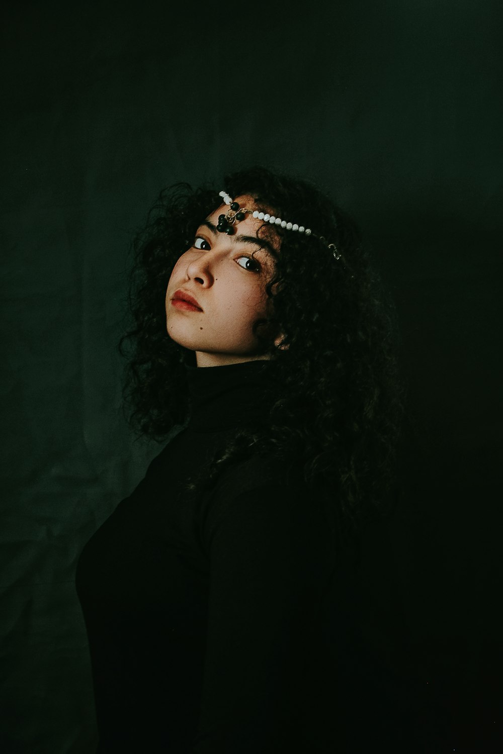 woman in black shirt with silver earrings