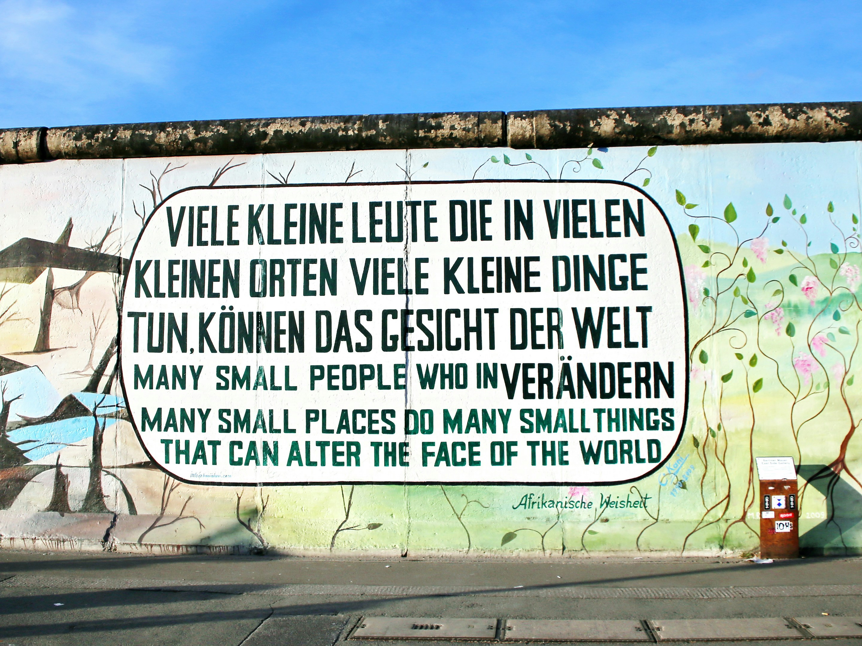 How to save our planet? This streetart is part of Berlin's East Side Gallery painted on former Berlin Wall illustrating what is needed for successful global change and transformation (climate change).