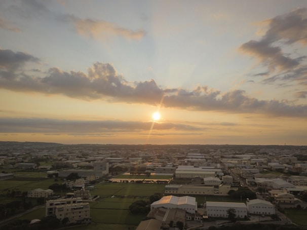 A panoramic view of Lehigh Acres cityscape at sunset, showcasing its peaceful neighborhoods and lush greenery.