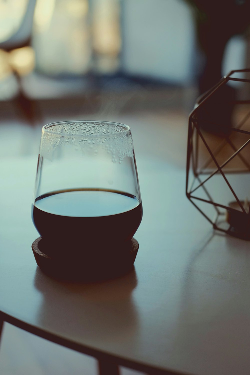 clear drinking glass with black liquid