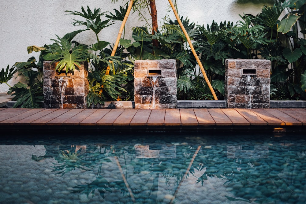 brown wooden ladder on swimming pool