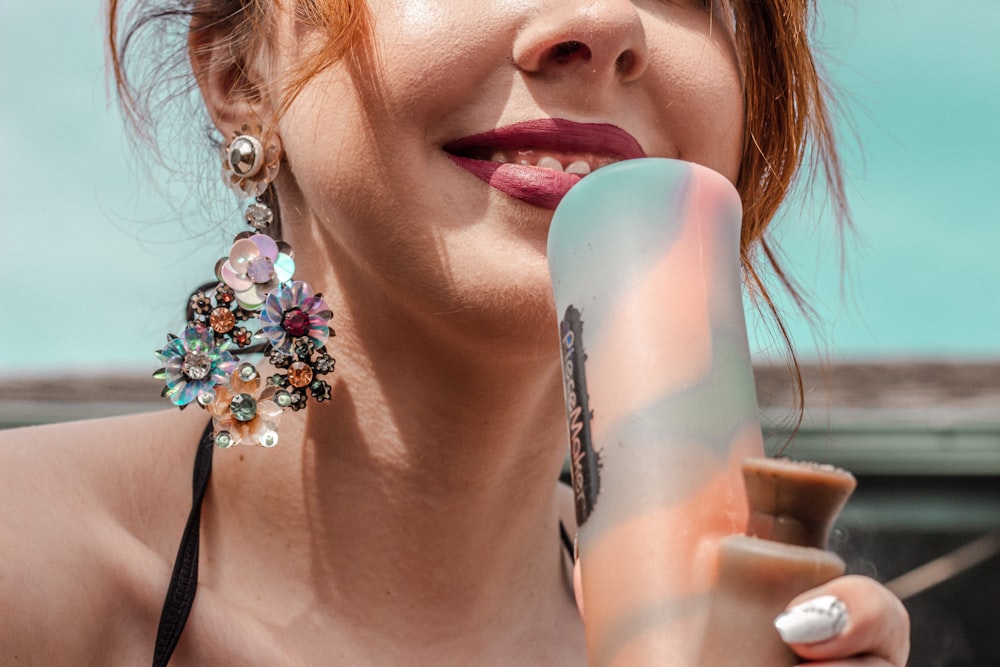 woman with blue and white flower on her mouth