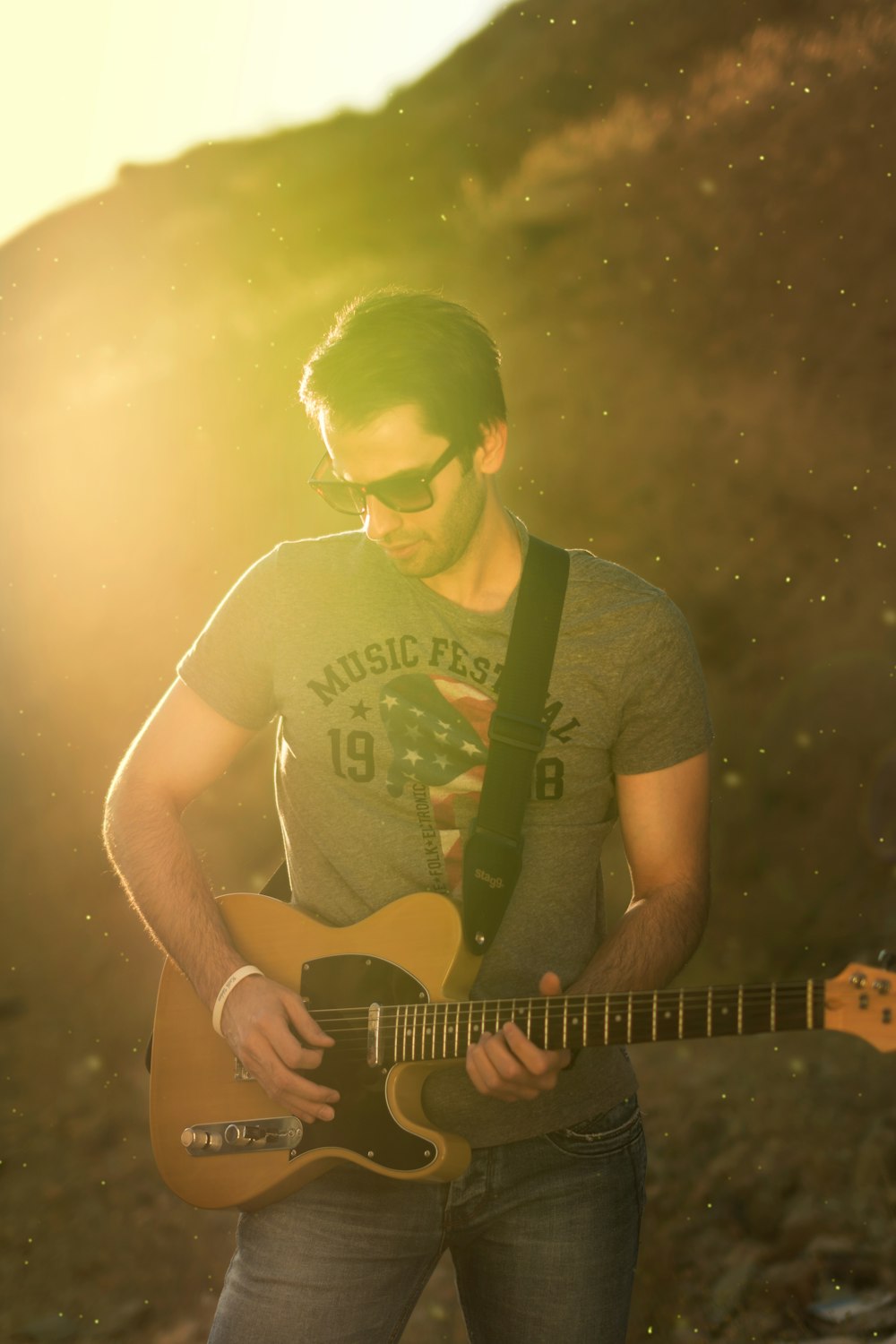 man in black crew neck t-shirt playing guitar