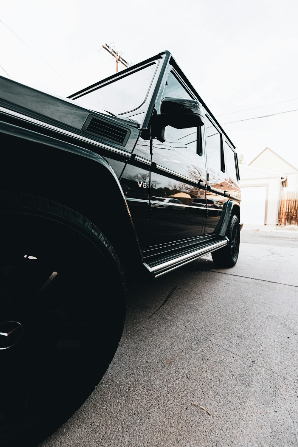 black car on gray concrete road during daytime