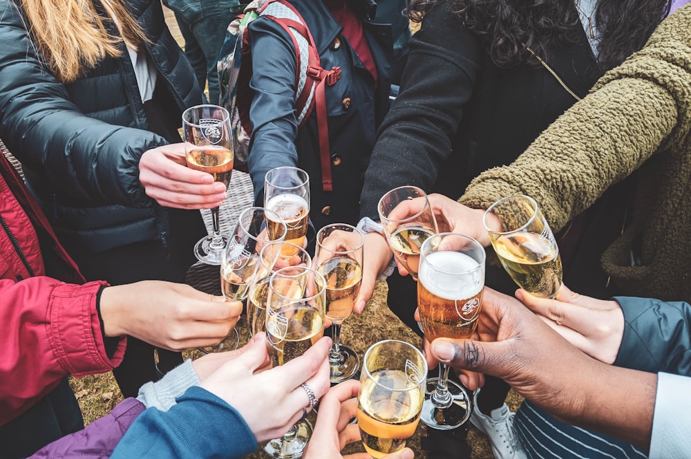 people holding clear drinking glasses