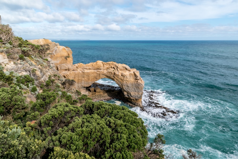 brown rock formation on sea during daytime