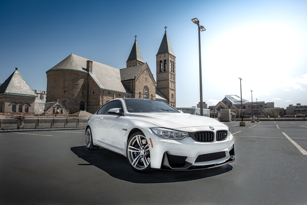 Coupé BMW blanc garé sur le bord de la route pendant la journée