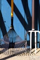 black and yellow umbrella on white metal fence