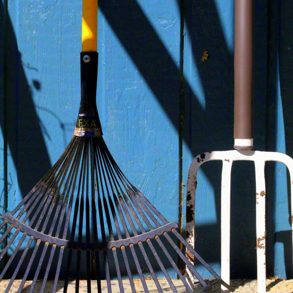 black and yellow umbrella on white metal fence