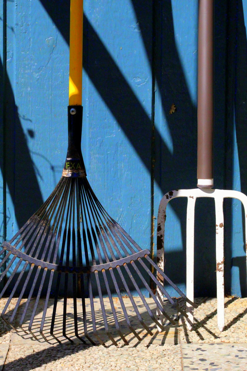 black and yellow umbrella on white metal fence