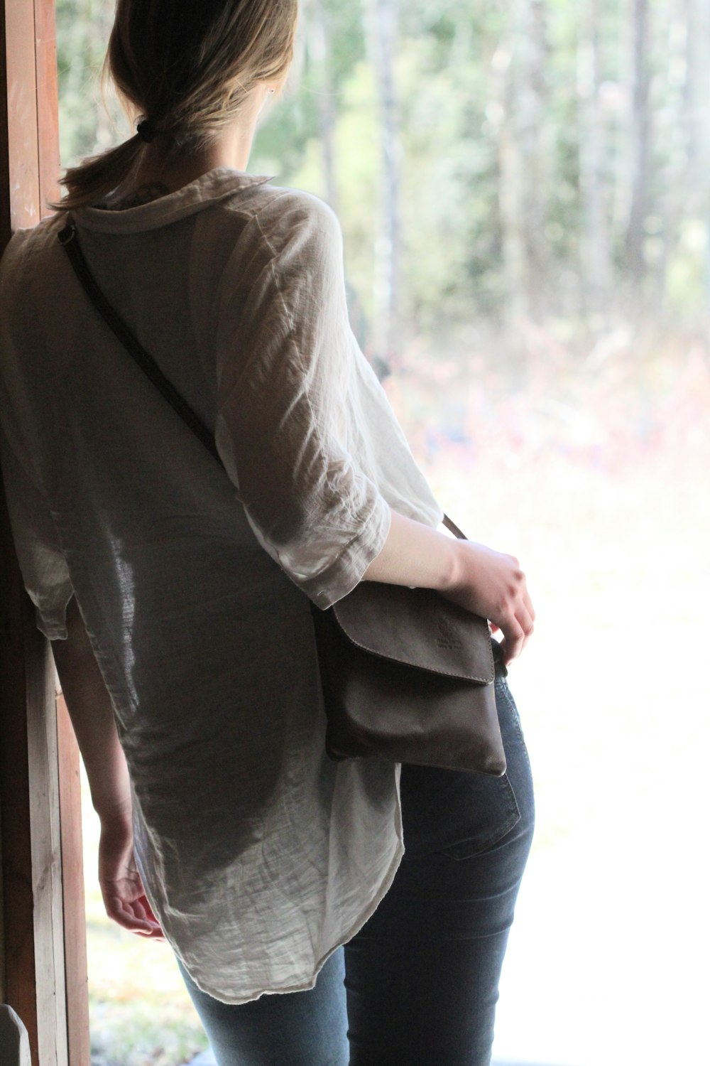 woman in gray long sleeve shirt and blue denim jeans