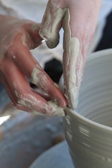 person holding white ceramic bowl