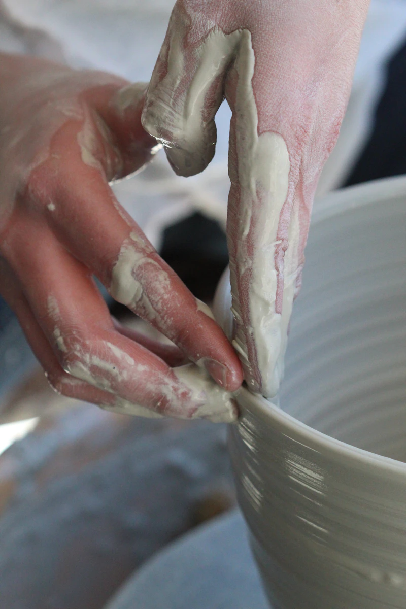 A potter glazing a bowl