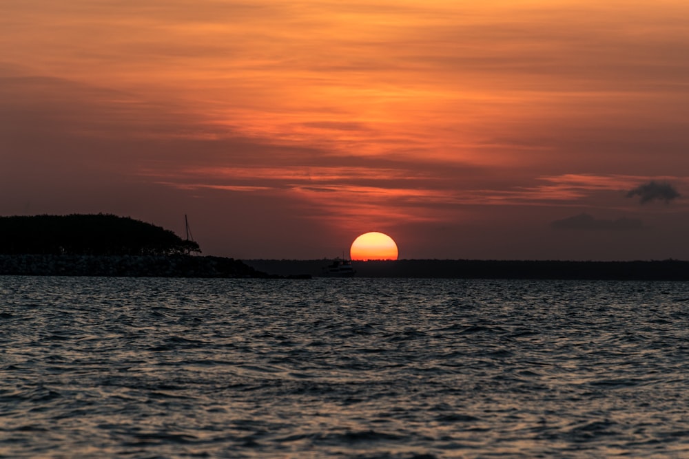 silhouette of island during sunset