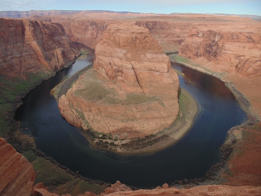 brown rock formation near river during daytime in Horseshoe Bend United States