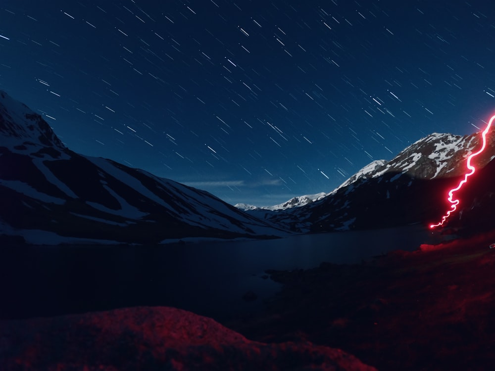 snow covered mountain under blue sky during night time