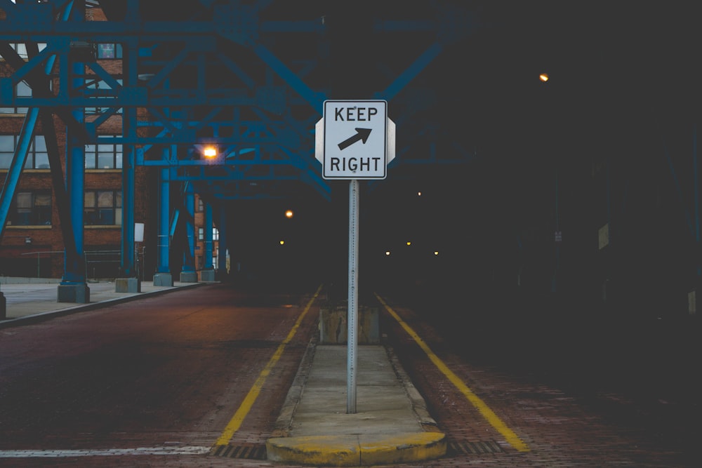 black and white street sign during night time