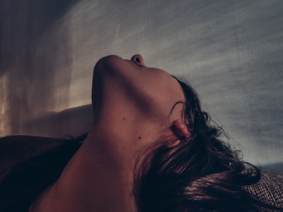 Side profile of a patient undergoing a non-invasive neck tightening procedure.