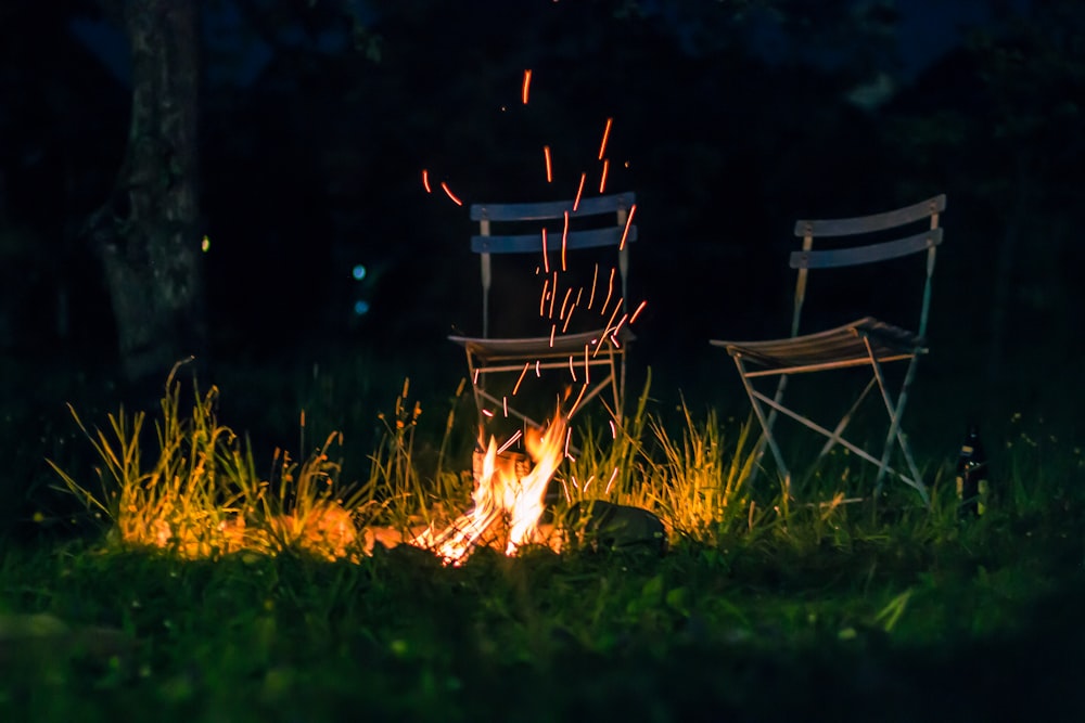 fire on green grass field during night time