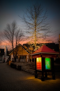 A night shot of Saint Gély du Fesc streets, illuminated with subtle golden streetlights.